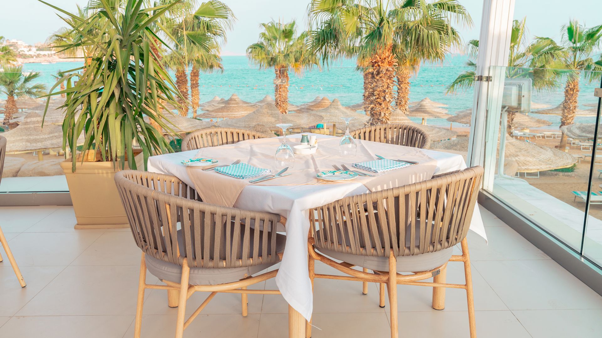 A Table With Chairs Around It By A Beach