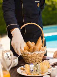 A Person Holding A Basket Of Food